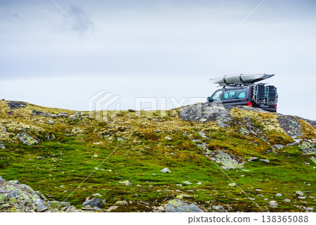 Car with canoe on top roof in mountains Car with canoe on top roof in mountains 138365088