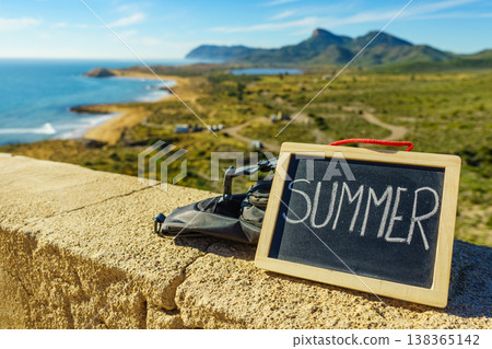 Black board with word summer against sea coast Black board with word summer against sea coast 138365142