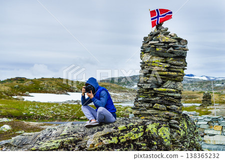 Tourist with camera in Norway mountains Tourist with camera in Norway mountains 138365232