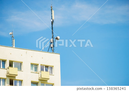 Cellular network antenna against blue sky. 138365241