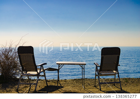 Tourist table and chairs on coast 138365277