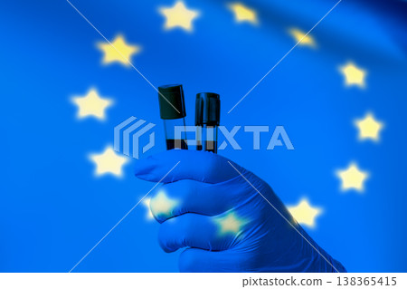 Vials of drugs in the hands of a doctor against the background of the flag of the European Union. The concept Vials of drugs in the hands of a doctor against the background of the flag of the European Union. The concept 138365415