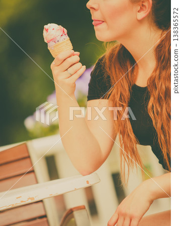 Young woman eating ice cream Young woman eating ice cream 138365572