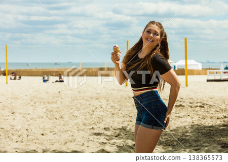 Young woman eating ice cream Young woman eating ice cream 138365573