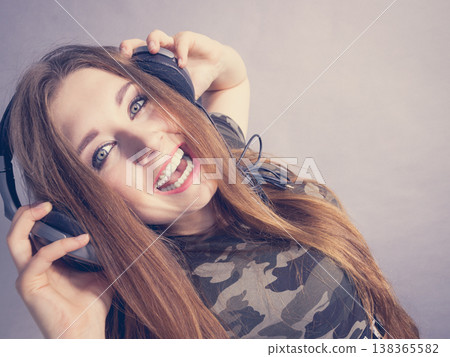 Teen women wearing headphones Teen women wearing headphones 138365582