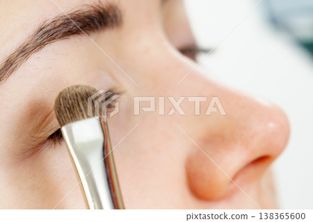 Makeup artist applying eye make up Makeup artist applying eye make up 138365600
