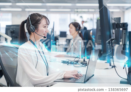 A smiling woman assisting customers at a call center. A smiling woman assisting customers at a call center. 138365697