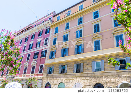Italy Rome balcony street pink house facade. Old building architecture in the city center. Italian window shutters Italy Rome balcony street pink house facade. Old building architecture in the city center. Italian window shutters 138365763