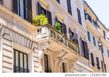 Italy Rome balcony street house facade. Old historical building architecture in the city center. Italian window shutters Italy Rome balcony street house facade. Old historical building architecture in the city center. Italian window shutters 138365766