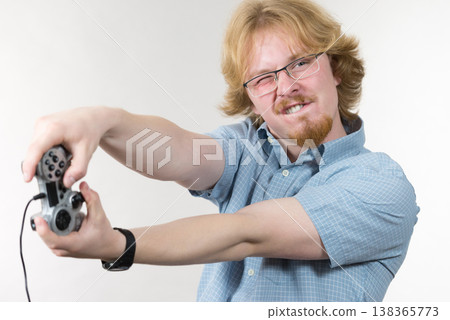 Gamer man holding gaming pad Gamer man holding gaming pad 138365773