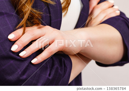 Woman standing with folded arms Woman standing with folded arms 138365784