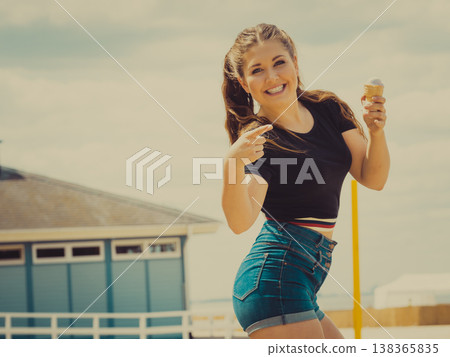 Young woman eating ice cream Young woman eating ice cream 138365835
