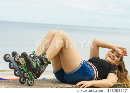 Girl wearing roller skates on seaside Girl wearing roller skates on seaside 138365837