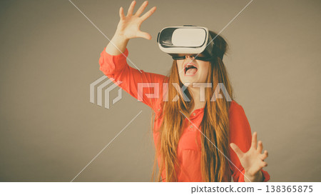 Girl wearing virtual reality goggles. Girl wearing virtual reality goggles. 138365875