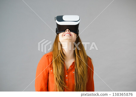 Girl wearing virtual reality goggles. Girl wearing virtual reality goggles. 138365876