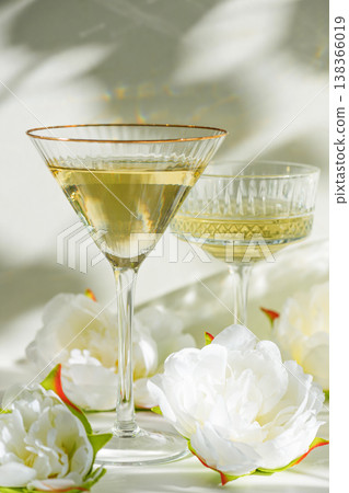 Champagne Glasses with White Peonies. Birthday or Wedding Celebration Arrangement. Champagne Glasses with White Peonies. Birthday or Wedding Celebration Arrangement. 138366019