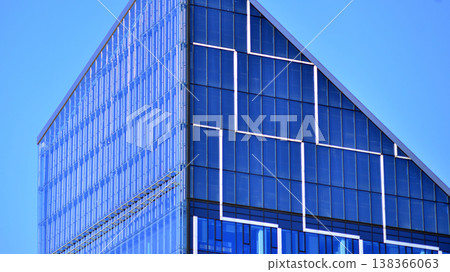 Modern office building with glass facade background. Transparent glass wall of office building. Modern office building with glass facade background. Transparent glass wall of office building. 138366063