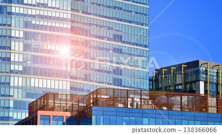 Modern office building with glass facade background. Transparent glass wall of office building. Modern office building with glass facade background. Transparent glass wall of office building. 138366066