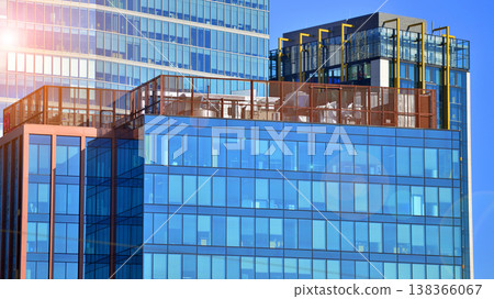 Modern office building with glass facade background. Transparent glass wall of office building. Modern office building with glass facade background. Transparent glass wall of office building. 138366067