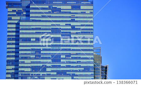 Modern office building with glass facade background. Transparent glass wall of office building. 138366071
