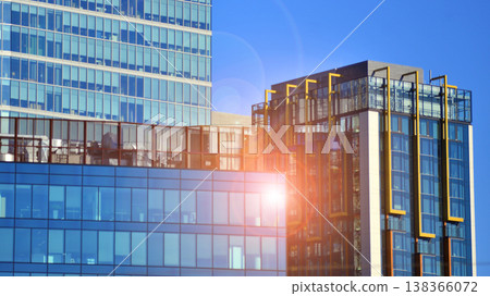 Modern office building with glass facade background. Transparent glass wall of office building. Modern office building with glass facade background. Transparent glass wall of office building. 138366072