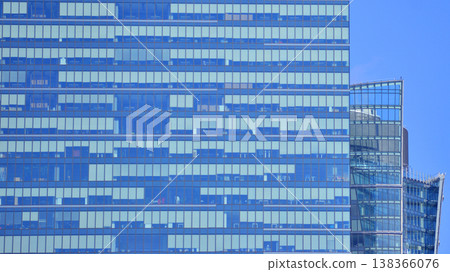 Modern office building with glass facade background. Transparent glass wall of office building. Modern office building with glass facade background. Transparent glass wall of office building. 138366076