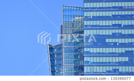 Modern office building with glass facade background. Transparent glass wall of office building. Modern office building with glass facade background. Transparent glass wall of office building. 138366077