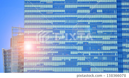 Modern office building with glass facade background. Transparent glass wall of office building. Modern office building with glass facade background. Transparent glass wall of office building. 138366078