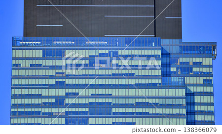 Modern office building with glass facade background. Transparent glass wall of office building. 138366079