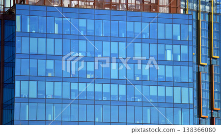 Modern office building with glass facade background. Transparent glass wall of office building. 138366080