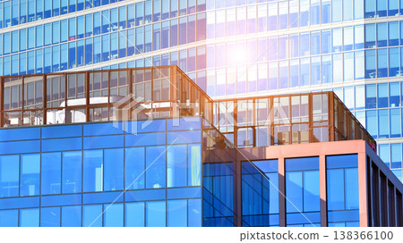 Modern office building with glass facade background. Transparent glass wall of office building. Modern office building with glass facade background. Transparent glass wall of office building. 138366100