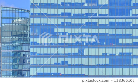 Modern office building with glass facade background. Transparent glass wall of office building. 138366105