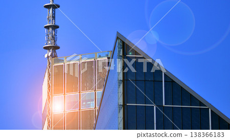 The glass exterior wall of the skyscrapers in the financial center. Tall glass skyscrapers in the city center. The glass exterior wall of the skyscrapers in the financial center. Tall glass skyscrapers in the city center. 138366183