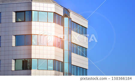 The glass exterior wall of the skyscrapers in the financial center. Tall glass skyscrapers in the city center. The glass exterior wall of the skyscrapers in the financial center. Tall glass skyscrapers in the city center. 138366184