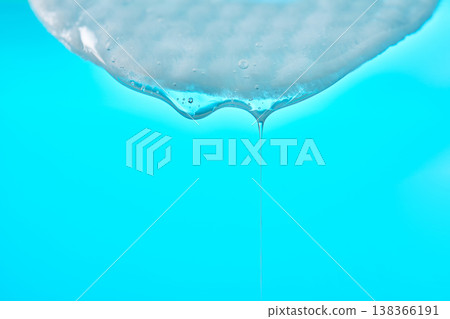 Viscous gel dripping from cotton pad beauty treatment 138366191