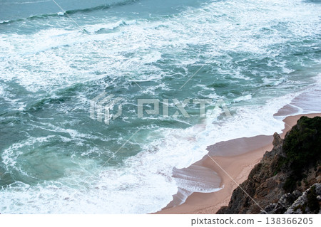 Cliff and Ocean Beach Scene with Rolling Waves Cliff and Ocean Beach Scene with Rolling Waves 138366205