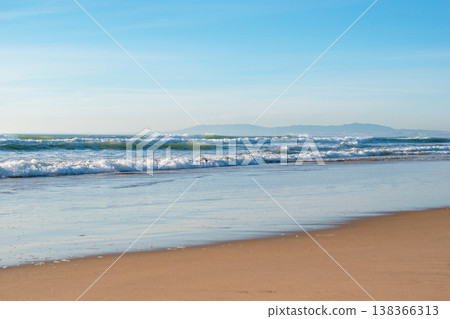 Ocean Waves Crashing on a Beach Shore Ocean Waves Crashing on a Beach Shore 138366313