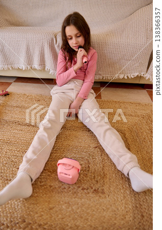 Young Girl Singing Karaoke At Home With Pink Microphone And Portable Speaker Young Girl Singing Karaoke At Home With Pink Microphone And Portable Speaker 138366357