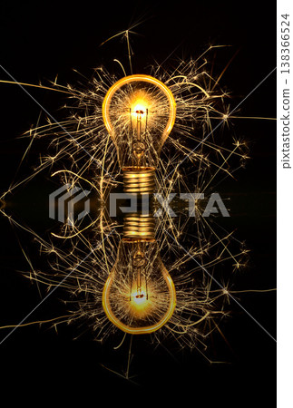 Light bulb sparkling in the dark and glowing glass Light bulb sparkling in the dark and glowing glass 138366524