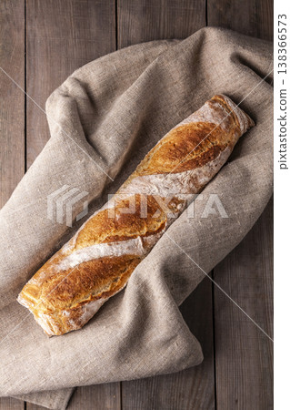 Freshly baked french baguette in on wooden background. High quality photo Freshly baked french baguette in on wooden background. High quality photo 138366573