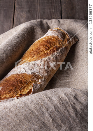 Freshly baked french baguette in on wooden background. High quality photo 138366577