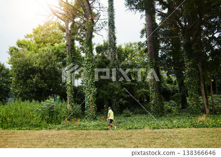 Senior man, exercise walk and forest in profile, adventure and outdoor for wellness in retirement. Mature person, fitness or workout for health, hiking or freedom in woods, countryside or nature park 138366646