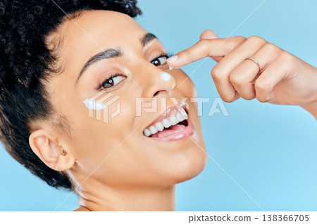Beauty skincare, portrait and happy woman with cream application of dermatology product for pimple, acne or spots prevention. Face makeup, studio cosmetics or aesthetic person on blue background Beauty skincare, portrait and happy woman with cream application of dermatology product for pimple, acne or spots prevention. Face makeup, studio cosmetics or aesthetic person on blue background 138366705