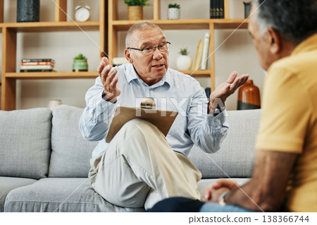 Senior man speaking to a psychologist at mental health, psychology and therapy clinic for session. Psychological therapist with clipboard for counseling checklist with elderly male patient in office. Senior man speaking to a psychologist at mental health, psychology and therapy clinic for session. Psychological therapist with clipboard for counseling checklist with elderly male patient in office. 138366744
