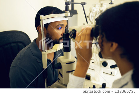 Man, eye exam and optometry for vision, medical and healthcare consultation with glaucoma check. Client and doctor or expert with laser, blue light or machine for scanning eyes and ophthalmology test Man, eye exam and optometry for vision, medical and healthcare consultation with glaucoma check. Client and doctor or expert with laser, blue light or machine for scanning eyes and ophthalmology test 138366753