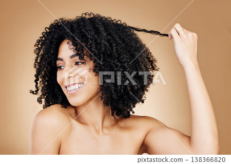 Curly, hair and strand of woman in studio for natural beauty, healthy growth and coil textures on brown background. Model, smile and pull afro hairstyle for salon aesthetic, keratin treatment or care Curly, hair and strand of woman in studio for natural beauty, healthy growth and coil textures on brown background. Model, smile and pull afro hairstyle for salon aesthetic, keratin treatment or care 138366820