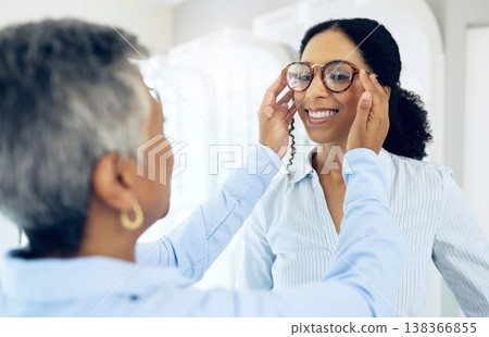 Optometrist, eye care service or happy woman with glasses for vision in a retail optical or eyewear shop. Women, choice or customer with new spectacles with a mature doctor at optics clinic store Optometrist, eye care service or happy woman with glasses for vision in a retail optical or eyewear shop. Women, choice or customer with new spectacles with a mature doctor at optics clinic store 138366855