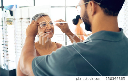 Optometrist, test glasses and measure pupil distance of mature woman for prescription lens, check or exam in store. Smile, optician or man writing on spectacles for eye health, vision or consultation Optometrist, test glasses and measure pupil distance of mature woman for prescription lens, check or exam in store. Smile, optician or man writing on spectacles for eye health, vision or consultation 138366865