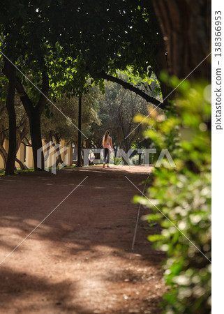 In a green city park, people running along the path 138366953
