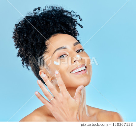 Beauty, studio portrait and happy woman with cream application, ointment product or lotion for skin hydration glow. Skincare treatment, protection and aesthetic model happiness on blue background Beauty, studio portrait and happy woman with cream application, ointment product or lotion for skin hydration glow. Skincare treatment, protection and aesthetic model happiness on blue background 138367138